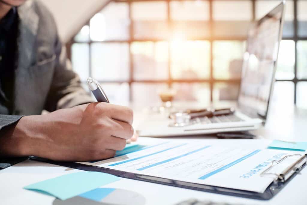 client completes health insurance paperwork to pay for rehab cost