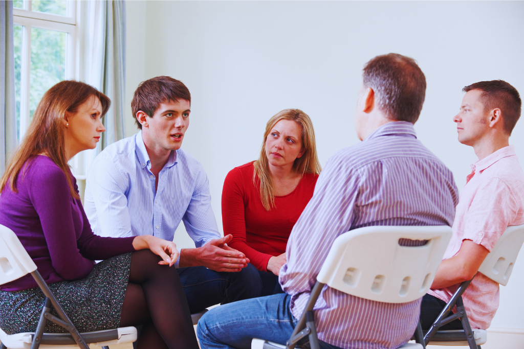A group of people sitting in a circle, engaged in a heartfelt discussion during a rehab session. This illustrates the support provided through Shively Kentucky Drug and Alcohol Rehab Resources to those seeking recovery.