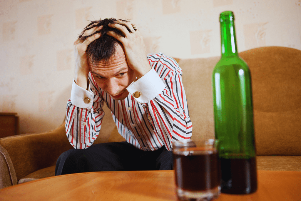 A man struggling with alcohol addiction, representing the need for Madisonville Kentucky Drug and Alcohol Rehab Resources, where individuals can find help and support for recovery.