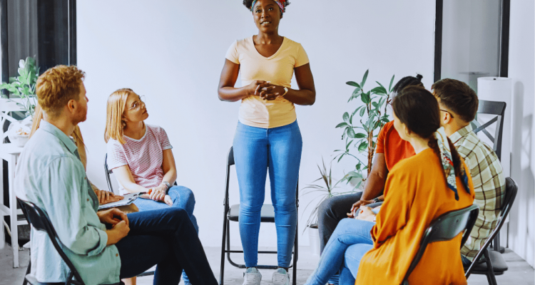 A woman sharing her story during a support group session, highlighting the role of Winchester Kentucky Drug and Alcohol Rehab Resources in addiction recovery.