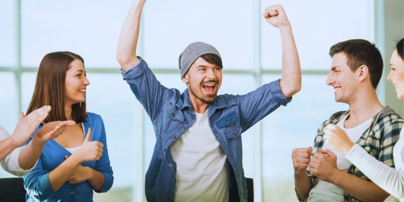 A group of individuals celebrating success in a recovery session, symbolizing the positive impact of Winchester Kentucky Drug and Alcohol Rehab Resources in supporting addiction recovery.