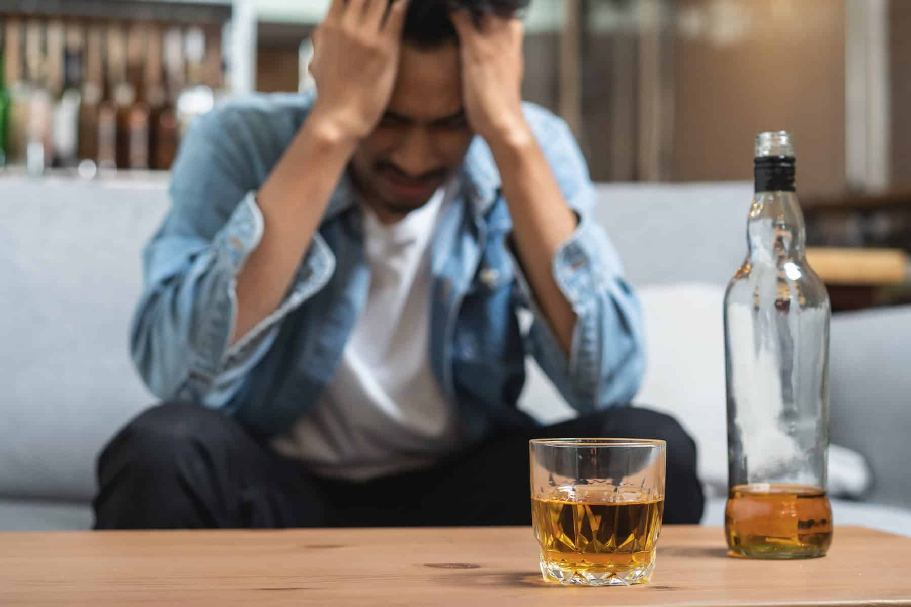 man drinks to numb emotions and has a drinking problem