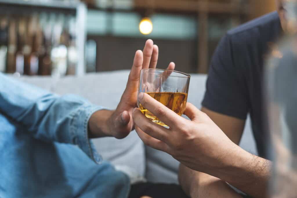 person refuses an alcoholic drink to begin rehab