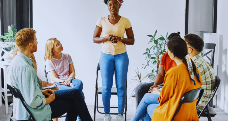 A woman sharing her story during a support group session, highlighting the role of Winchester Kentucky Drug and Alcohol Rehab Resources in addiction recovery.