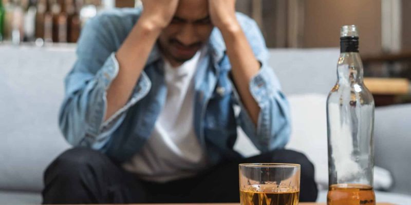 man drinks to numb emotions and has a drinking problem